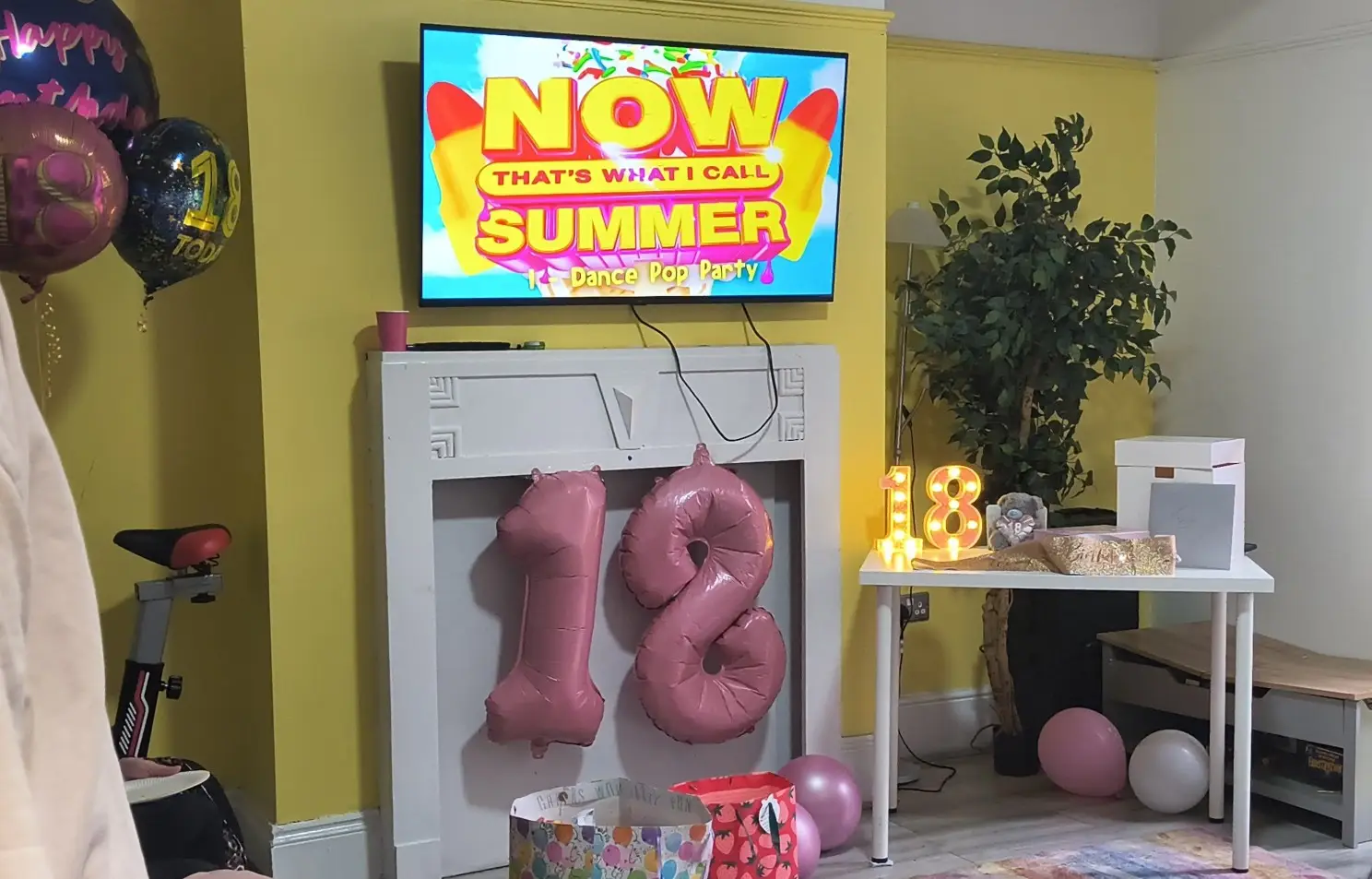 YP's 18th birthday celebration, with the living room at Enidaso House decorated with balloons, gifts and music.