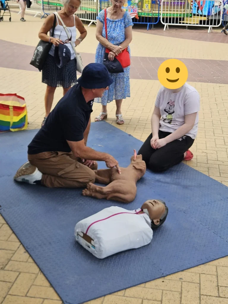 Young person participating in a free Dog CPR workshop at Barry Island.