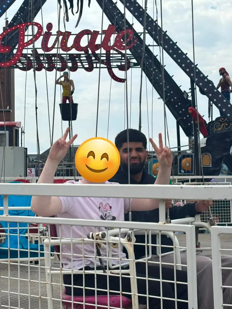 Young person enjoying swings ride at Barry Island.