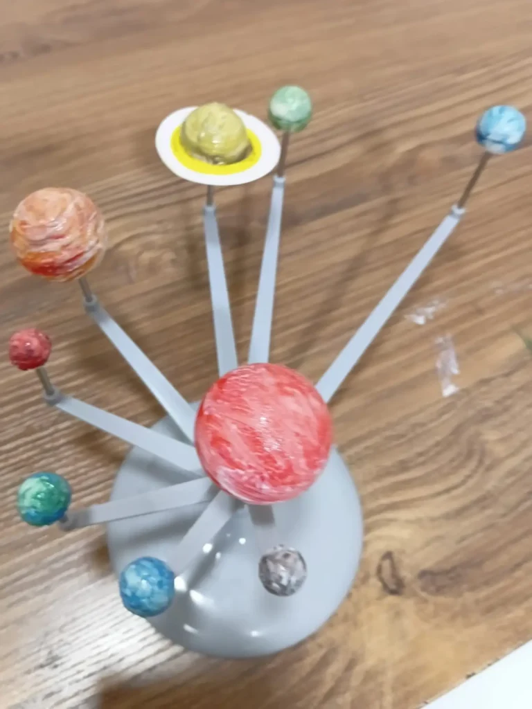 Handmade solar system model created during a planet painting and arts activity.