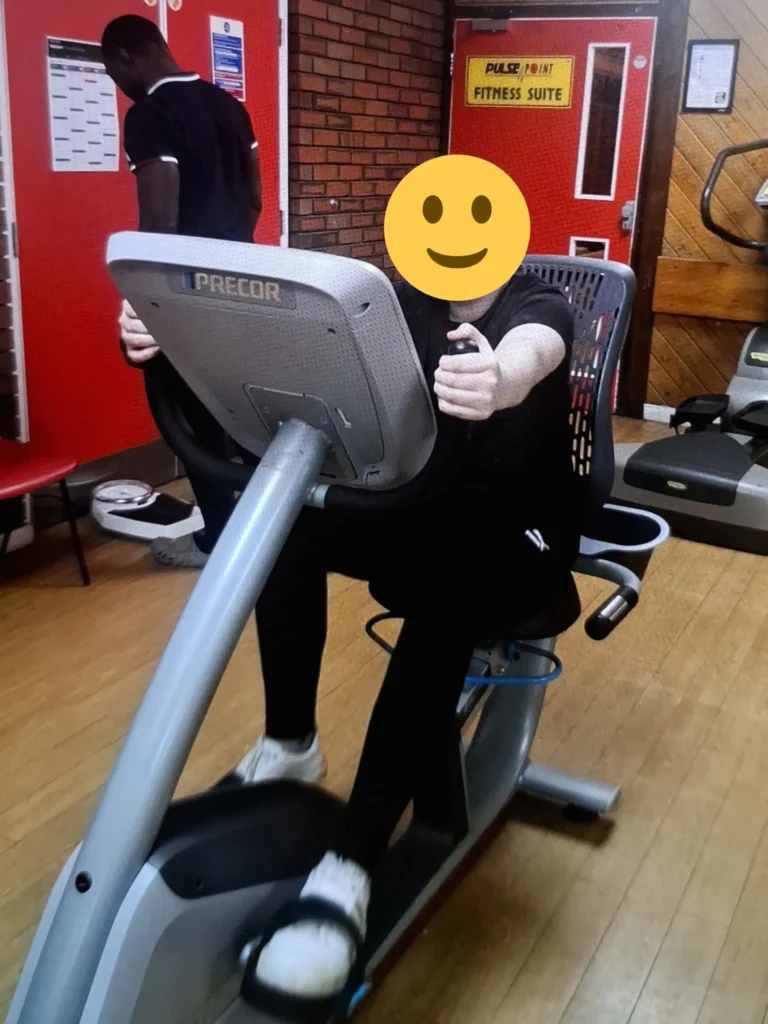 Young person using an exercise bike as part of a regular gym workout routine.