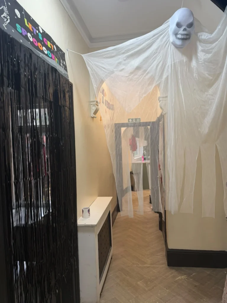 Halloween ghost decoration hanging in the hallway of a residential care home