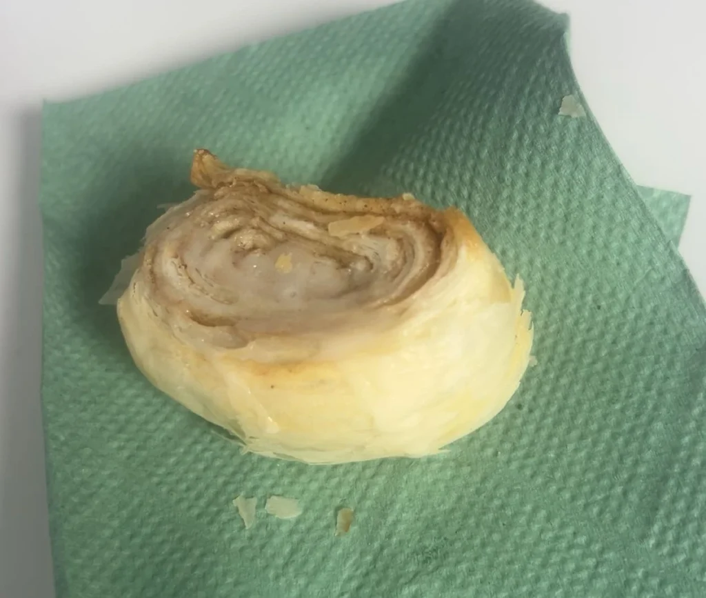 Freshly baked homemade cinnamon roll made by a young person at Enidaso House.