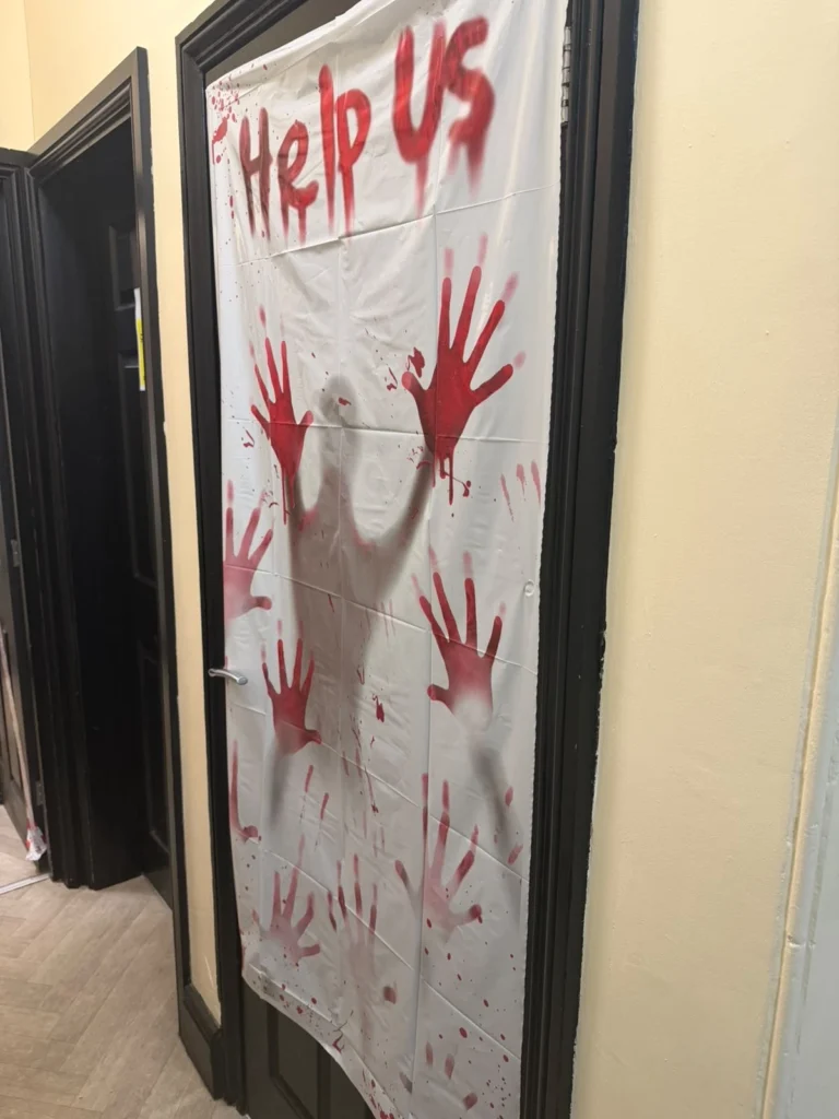 Halloween themed door decoration with spooky handprints in a residential care home